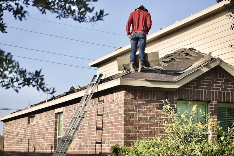 Professional roofer working on a residential roof in Courtland